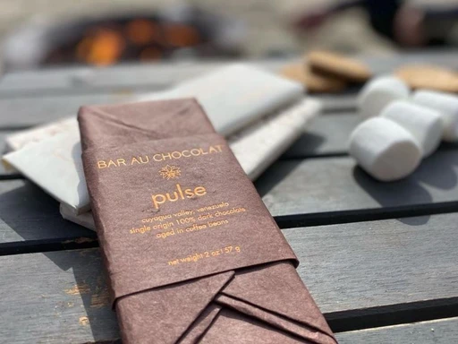 A tempestuous combination of art and science merge in this California chocolate lab.
Founded in 2010 by Nicole Trutanich, Bar au Chocolat is a labor of love.
Beginning with sustainable farming practices, the company crafts small quantities of high-end chocolates using only two ingredients, bringing out the taste of the cacao beans. Taste the authenticity of the dark chocolate bars, as the beans shine through and laissez les bons temps rouler! Make sure to try the hot chocolate and roasted cacao nibs to round out your pantry, and let these delectable sweets brighten up your day.